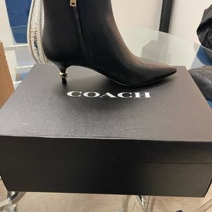 Women’s leather Coach heeled boots.